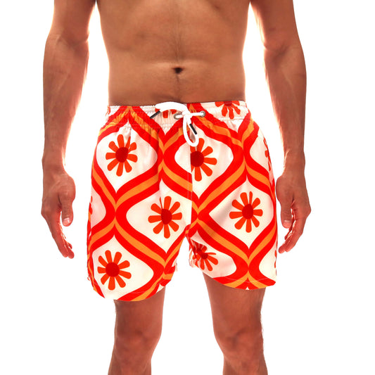 Red and white patterned swim shorts on a white background