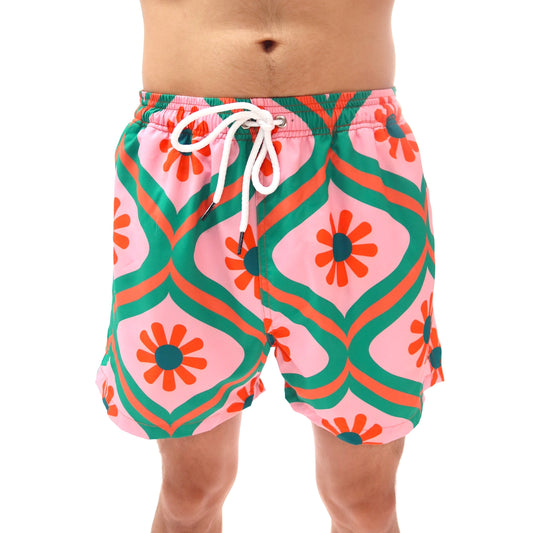 Colorful geometric patterned swim shorts on a white background
